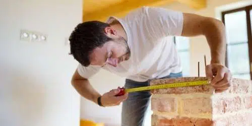 Man Measuring for a Furnace Install